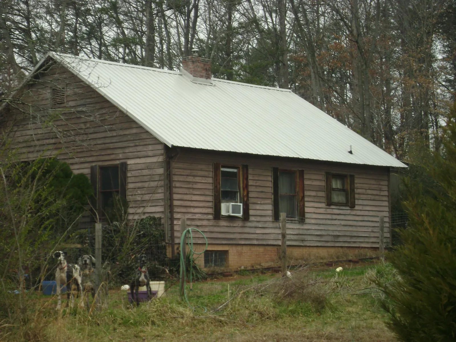 White metal roof on an old wood sided farmhouse, from a Metal Roof Installation job in Mc Calla